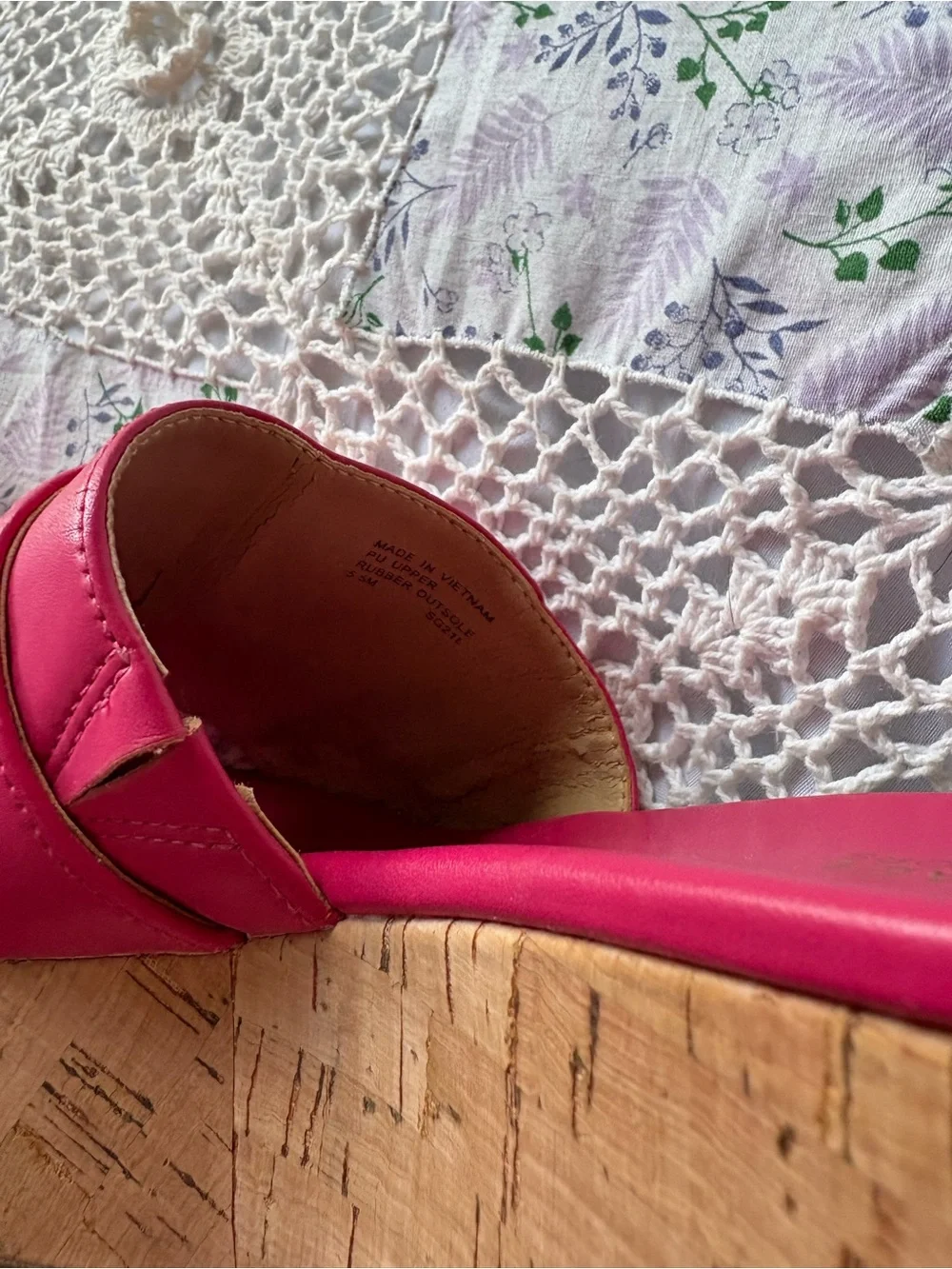 Michael Kors bright pink platform slide sandals with a cork wedge.